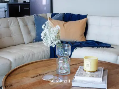 a coffee table with a vase on top of a table at Sea View 2BR in Dubai Marina near Dubai Eye in Dubai