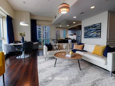a living room with a couch and a table at Sea View 2BR in Dubai Marina near Dubai Eye in Dubai