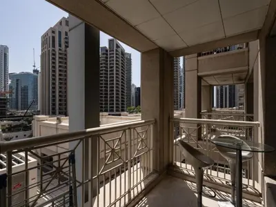 a balcony with a table and chairs and a view of the city at The Havenette comfy Studio in 29 BLVD Walk in Dubai