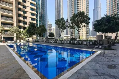 a large swimming pool in a city with tall buildings at The Havenette comfy Studio in 29 BLVD Walk in Dubai