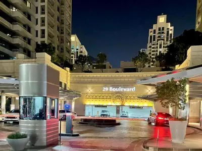 a building with a gas station in a city at night at The Havenette comfy Studio in 29 BLVD Walk in Dubai