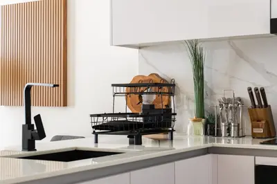 a kitchen with a black rack on the counter at SettlerHomes - JVC Skyline Views - Pool & Gym in Dubai