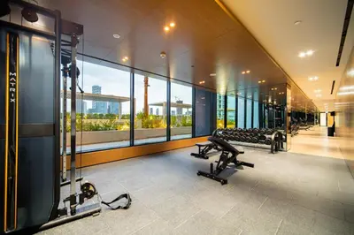 a gym with cardio equipment in a building at SettlerHomes - JVC Skyline Views - Pool & Gym in Dubai