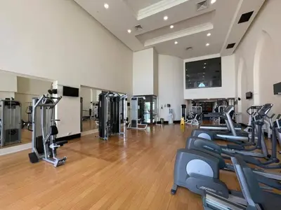 a gym with a row of treadmills and machines at Deluxe Arabian-Inspired One Bedroom Stay in Souk Al Bahar Downtown Dubai in Dubai