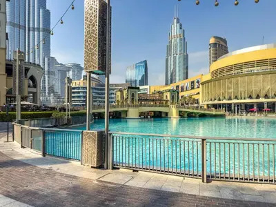 a bridge over a river in a city with tall buildings at Deluxe Arabian-Inspired One Bedroom Stay in Souk Al Bahar Downtown Dubai in Dubai