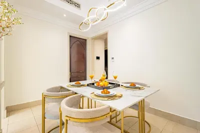 a dining room with a table with glasses of wine at Deluxe Arabian-Inspired One Bedroom Stay in Souk Al Bahar Downtown Dubai in Dubai