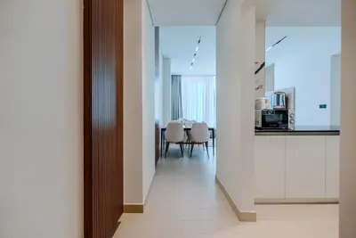 a hallway leading to a kitchen and a dining room at TRPS - Trillionaire Residences, Business Bay - Private Jacuzzi, Modern 2BR Furnished, Canal View in Dubai