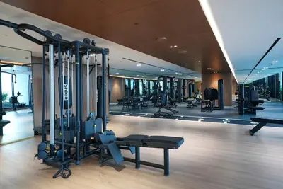 a gym with lots of equipment in a building at TRPS - Trillionaire Residences, Business Bay - Private Jacuzzi, Modern 2BR Furnished, Canal View in Dubai