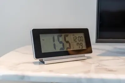a clock sitting on top of a table at Bright & Modern 1BR in Dubai Marina in Dubai