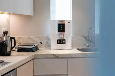 a kitchen with a coffee maker on a counter at Bright & Modern 1BR in Dubai Marina in Dubai