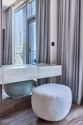 a desk with a mirror and a chair in a room at Frank Porter - J One Tower in Dubai