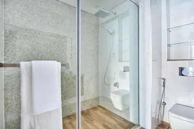 a bathroom with a shower and a toilet at Frank Porter - J One Tower in Dubai