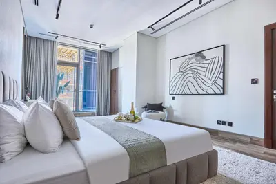 a bedroom with a large white bed and a window at Frank Porter - J One Tower in Dubai