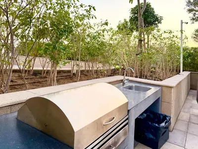 a kitchen with a sink in a garden at Panoramic Apartment with Smart TV&Large Terrace in Dubai