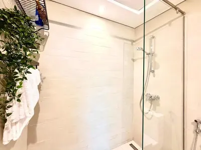 a bathroom with a shower with a glass door at Panoramic Apartment with Smart TV&Large Terrace in Dubai