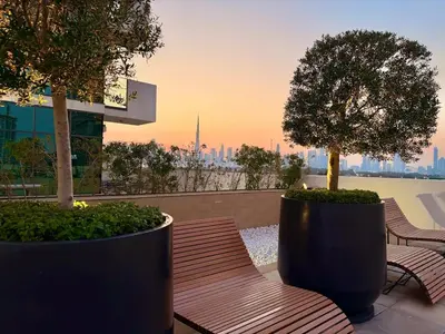 two benches and a tree on top of a building at Panoramic Apartment with Smart TV&Large Terrace in Dubai
