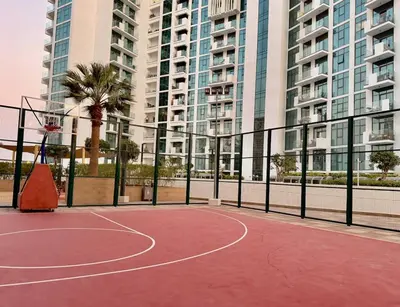 a basketball court in front of some tall buildings at Panoramic Apartment with Smart TV&Large Terrace in Dubai