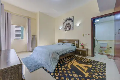 a bedroom with a bed and a large window at Dreamy heaven Spacious 2BR Apt with marina view in Dubai