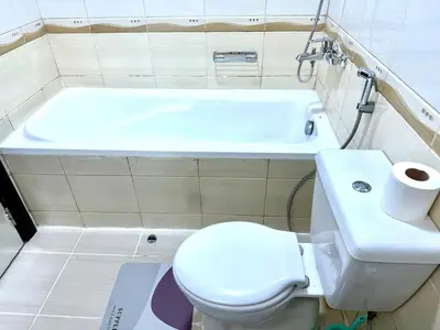 a bathroom with a toilet and a bath tub at Dreamy heaven Spacious 2BR Apt with marina view in Dubai