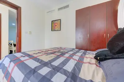 a bedroom with a bed with a colorful comforter at Dreamy heaven Spacious 2BR Apt with marina view in Dubai