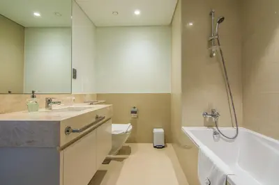 a bathroom with a shower and a sink and a toilet at One Bedroom Apartment with Balcony in Act One Act Two, Downtown in Dubai