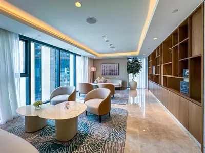 a hotel lobby with chairs and tables and windows at One Bedroom Apartment with Balcony in Act One Act Two, Downtown in Dubai