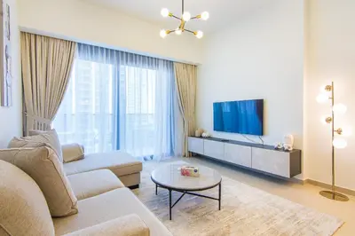 a living room with a couch and a tv at One Bedroom Apartment with Balcony in Act One Act Two, Downtown in Dubai