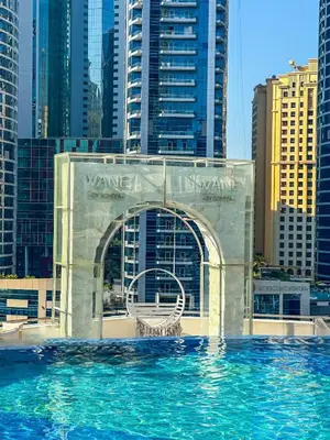 a view of a pool in a city with tall buildings at Marina View Studio with Balcony in Dubai
