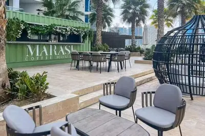 a group of chairs and tables in front of a restaurant at Vogue Business Bay Damac Maison Prive near Burj Khalifa and Dubai Mall, Studio Apartment with Balcony, City and Canal View, Access to all Amenities in Dubai