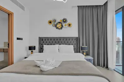 a bedroom with a large white bed and a window at Full Marina view luxury apartment in Dubai in Dubai