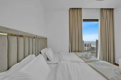 a bedroom with two beds and a large window at Full Marina view luxury apartment in Dubai in Dubai