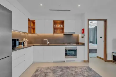 a kitchen with white cabinets and a sink at Full Marina view luxury apartment in Dubai in Dubai