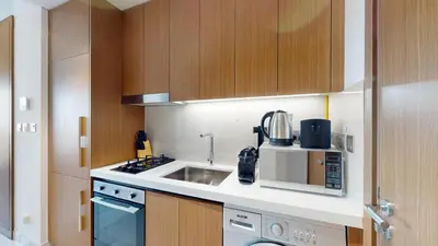 a kitchen with a sink and a microwave at Vacationer l Modern Studio l Community Views l Free Gym, Pool in Dubai