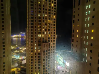 a view of a city at night with tall buildings at ZAH Luxury Holiday Home at JBR,Dubai in Dubai