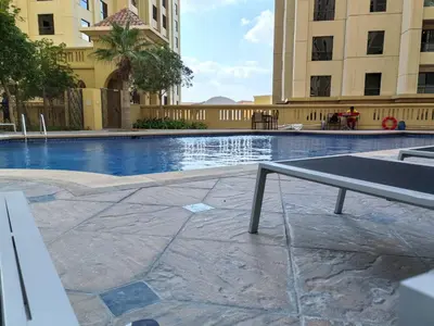 a ping pong table in the middle of a swimming pool at ZAH Luxury Holiday Home at JBR,Dubai in Dubai