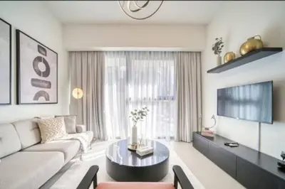 a living room with a couch and a table at Oshima Act Two Downtown 1BR Burj Khalifa in Dubai