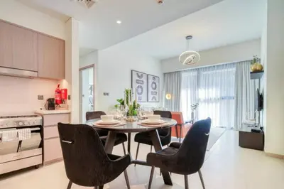 a kitchen and dining room with a table and chairs at Oshima Act Two Downtown 1BR Burj Khalifa in Dubai