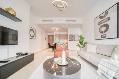 a living room with a couch and a table at Oshima Act Two Downtown 1BR Burj Khalifa in Dubai
