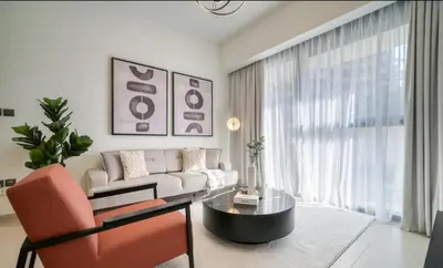 a living room with a couch and a table at Oshima Act Two Downtown 1BR Burj Khalifa in Dubai