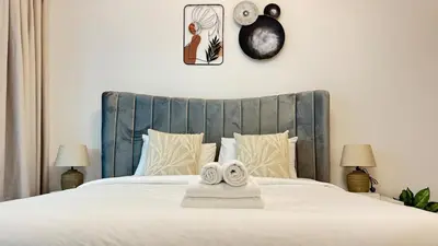 a bedroom with a bed with two towels on it at Studio in central location near the Metro in Dubai