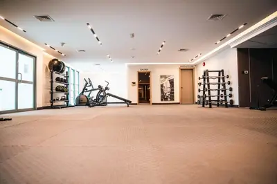 a gym with treadmills and exercise equipment in a building at Studio in central location near the Metro in Dubai