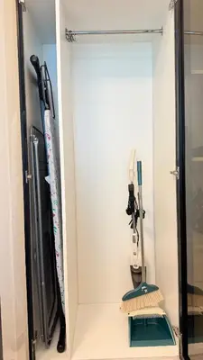 a closet with two hockey sticks and a mirror at Studio in central location with Balcony nearby Metro in Dubai