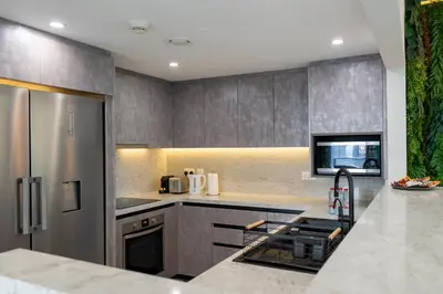 a kitchen with stainless steel appliances and a counter top at Werova - Luxury 2BR Apartment w Breathtaking View in Dubai
