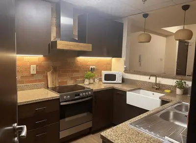 a kitchen with a sink and a stove top oven at Luxury Entire 3 bed rooms with 3 bathrooms in Dubai