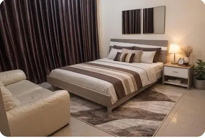 a bedroom with a large bed and a chair at Luxury Entire 3 bed rooms with 3 bathrooms in Dubai