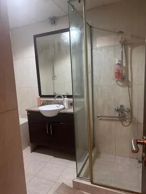 a bathroom with a glass shower and a sink at Luxury Entire 3 bed rooms with 3 bathrooms in Dubai