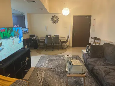 a living room with a couch and a flat screen tv at Luxury Entire 3 bed rooms with 3 bathrooms in Dubai
