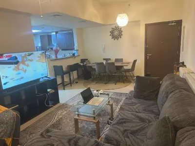 a living room with a couch and a flat screen tv at Luxury Entire 3 bed rooms with 3 bathrooms in Dubai