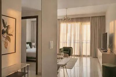 a hotel room with a bed and a living room at 30th Floor Creek Harbour 1 Bedroom Apartment in Dubai