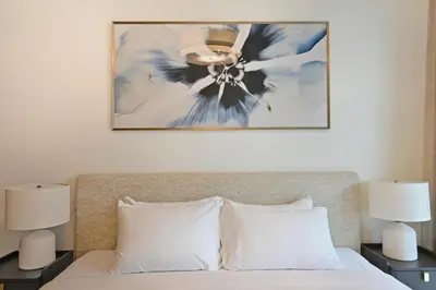a bedroom with a bed with a ceiling fan at Grand Bleu by Elie Saab Residency, Private Beach - Dubai Harbour - 2BR in Dubai